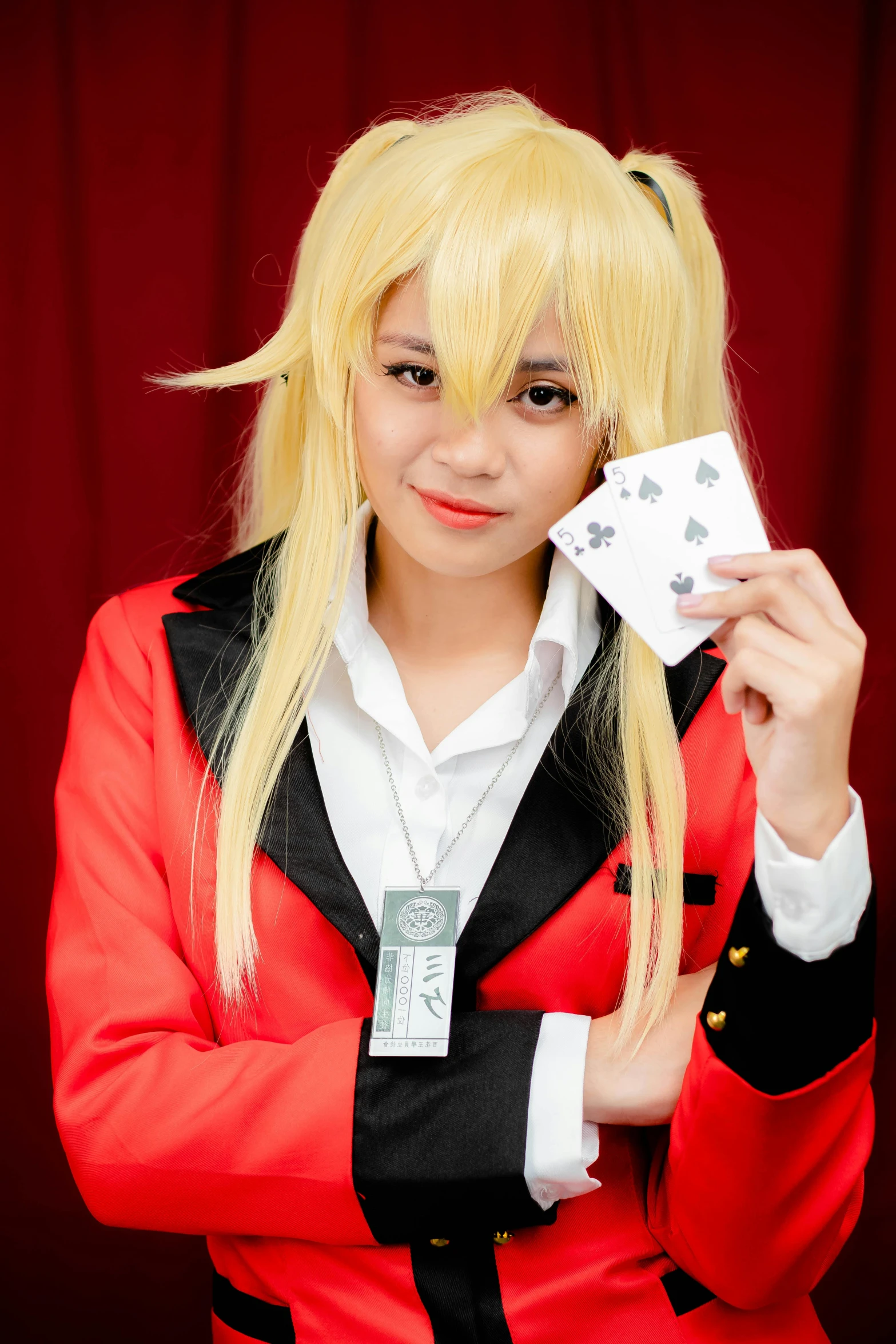 an anime girl in a red jacket holding a card