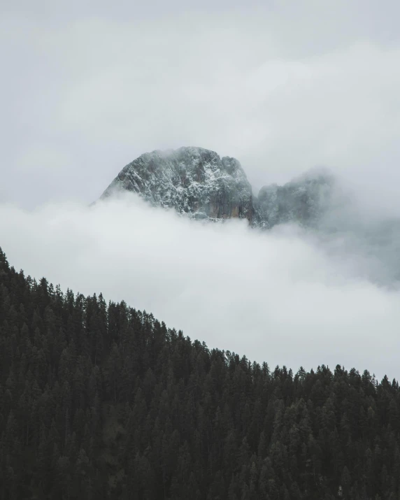 a mountain covered in mist and low lying clouds