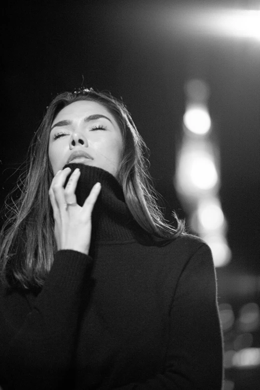 a woman standing with her mouth open holding a cell phone up to her ear