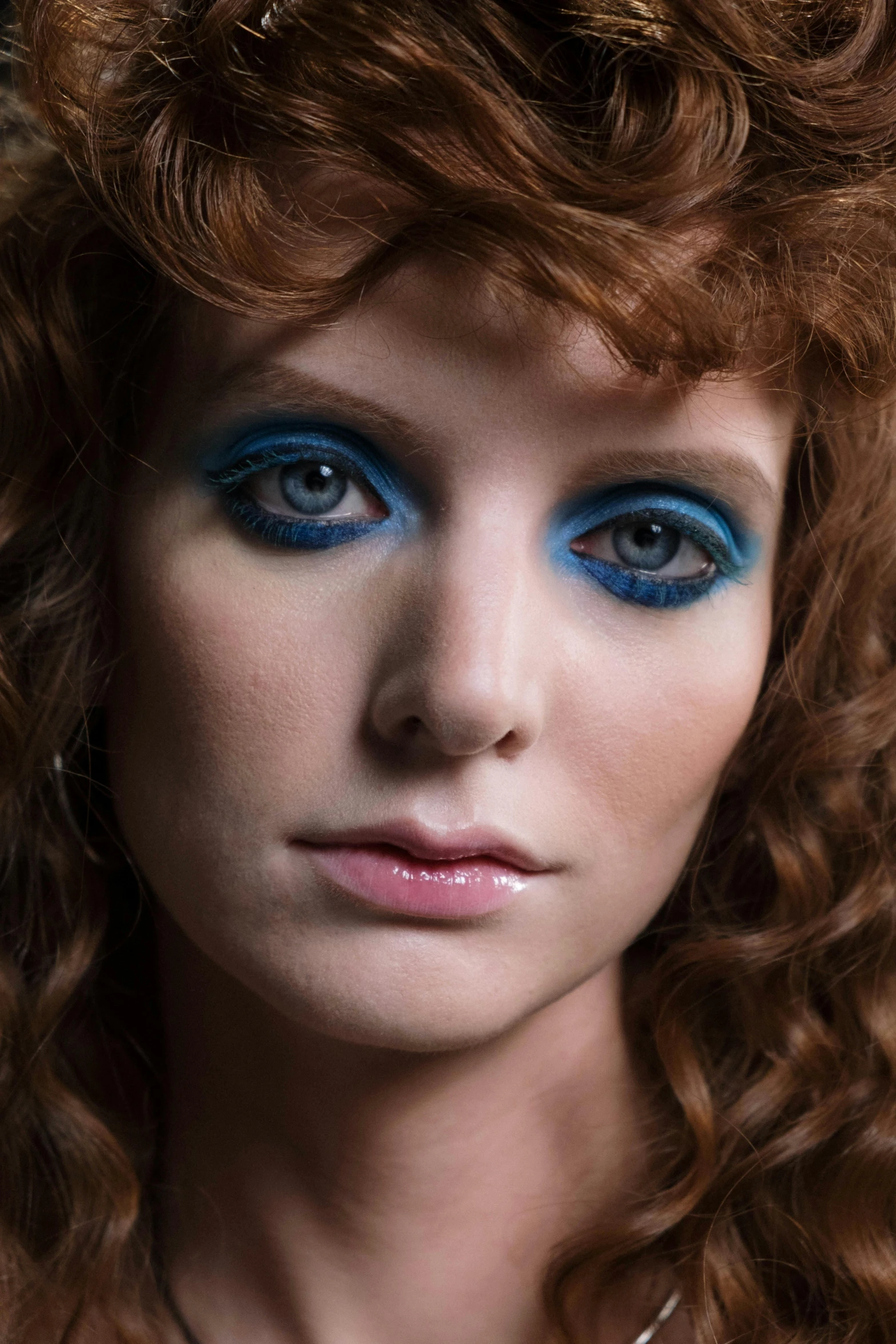 an image of woman with blue eye makeup