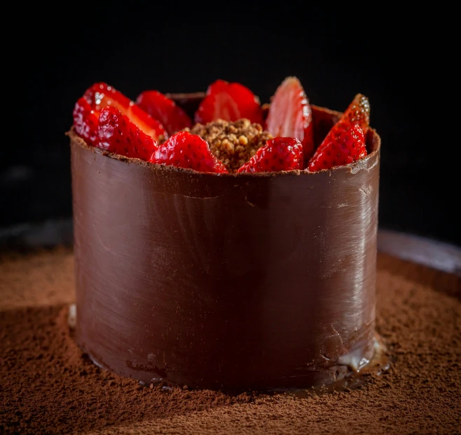 the chocolate cake has two different toppings and is topped with fresh strawberries