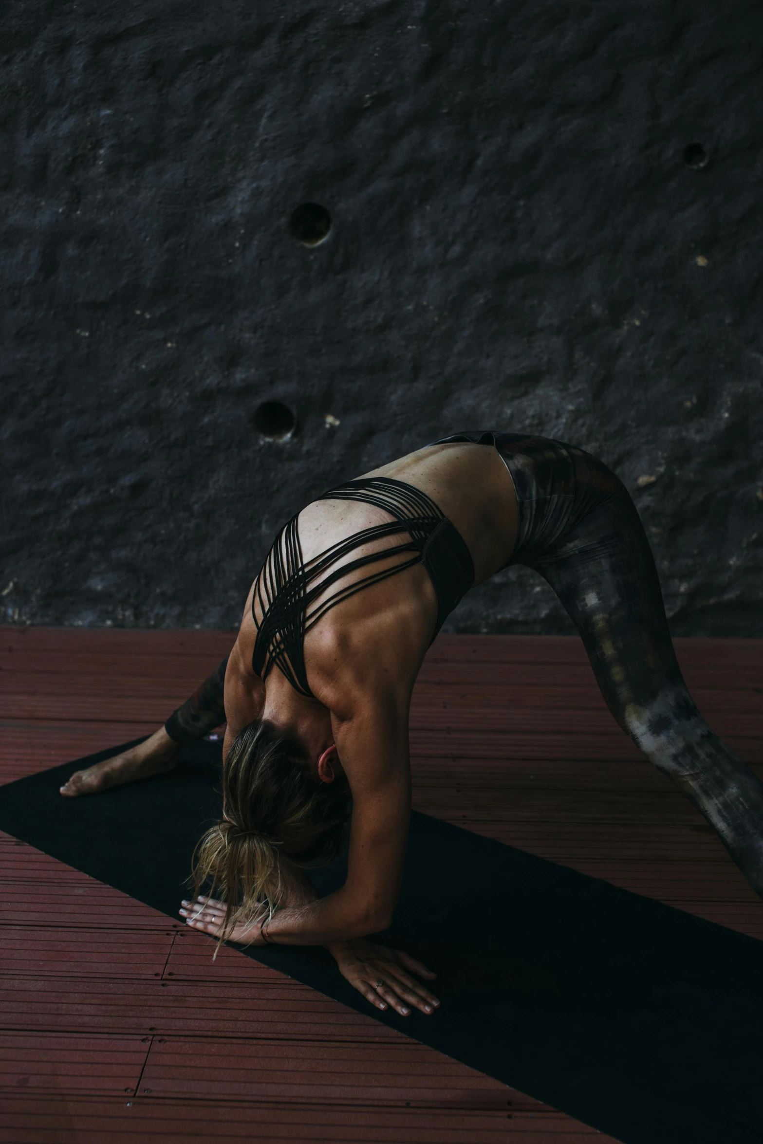 a person is standing on their stomach doing an upward back pose