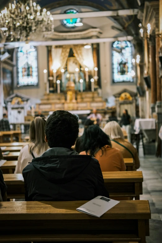 people sitting in pews during a mass