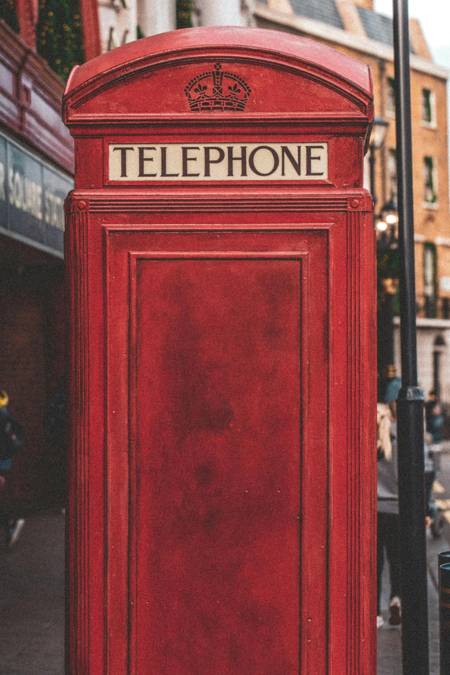 a red telephone booth on a city street