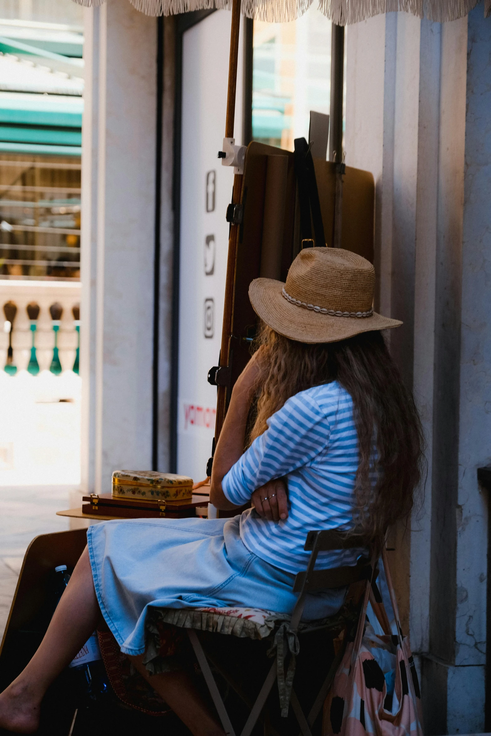 the woman is sitting on the chair and waiting for her turn