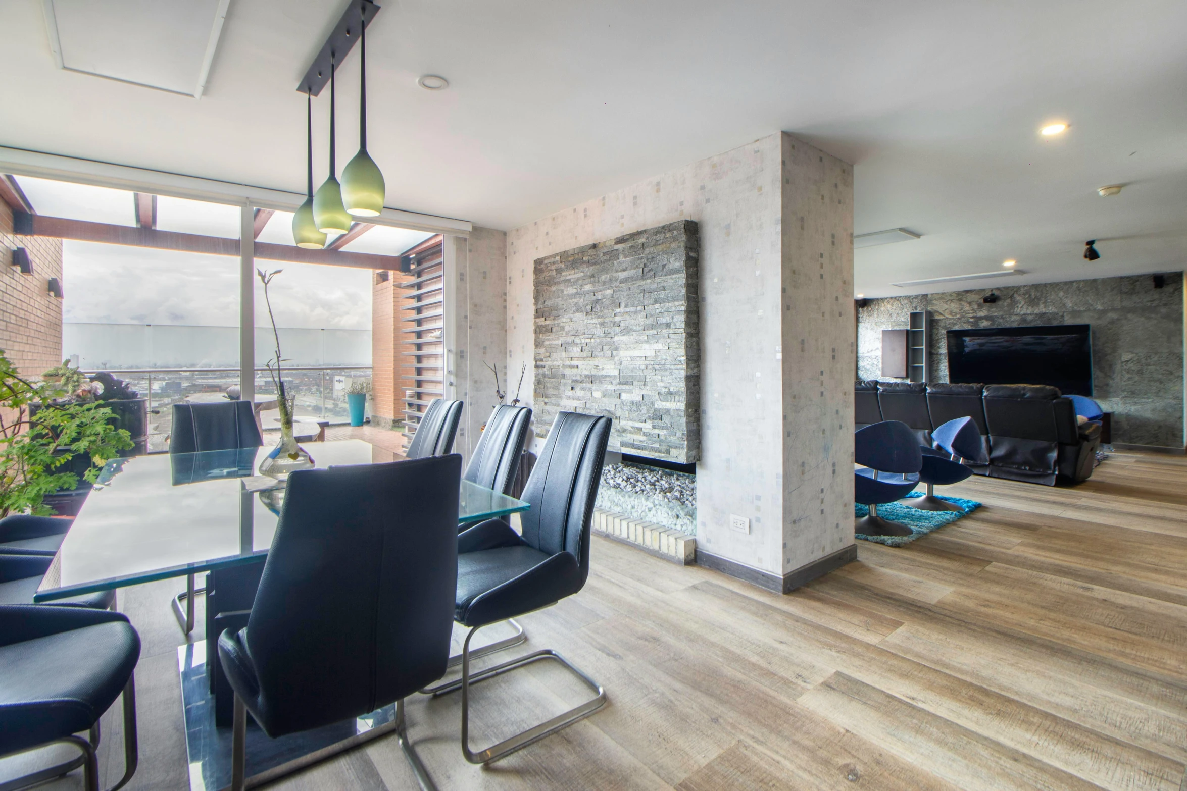 a glass table with black chairs sitting in a room