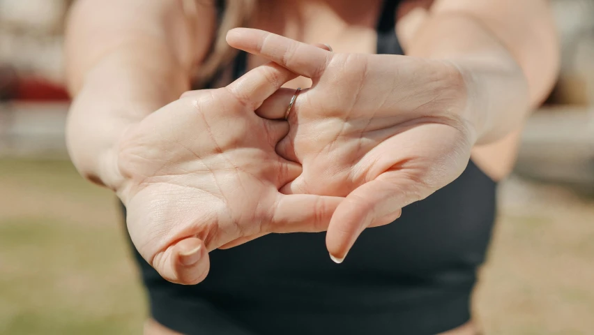 a woman in a sports  with her hands together