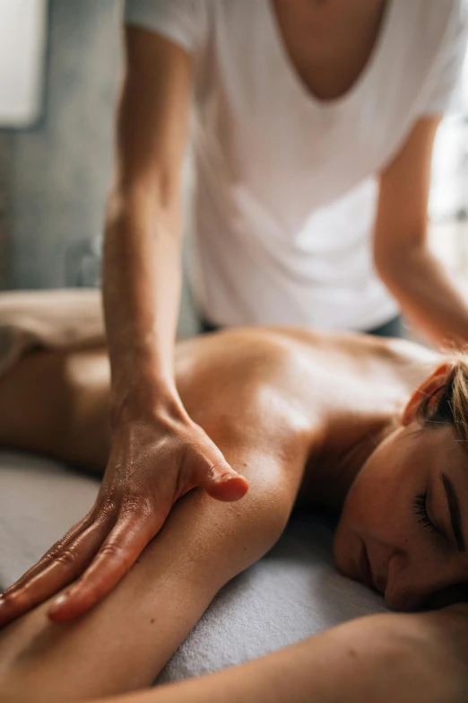 a person doing a back massage with one hand on another