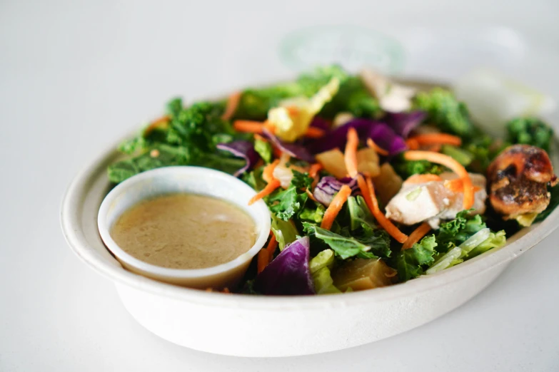 a plate of food with dressing in the center