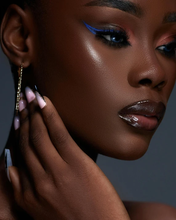 a black woman with her face in shadows and wearing statement earrings