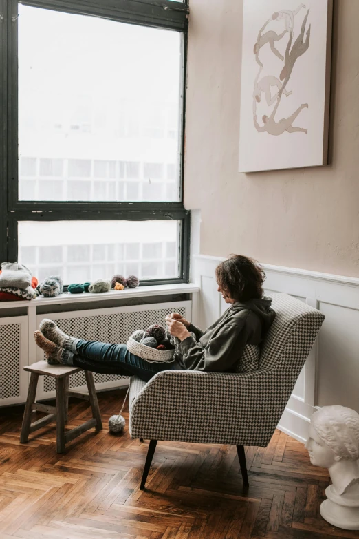 a woman in a chair using her phone