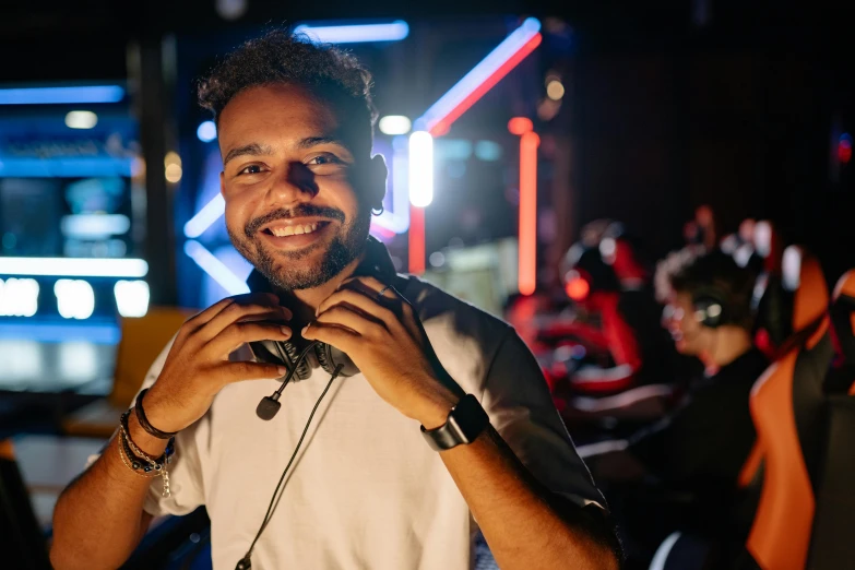 a man with headphones smiles at the camera