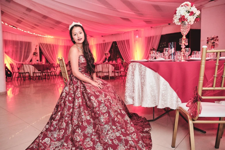 a young lady sitting in front of a wedding table