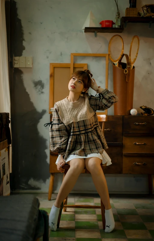 a woman sits on a chair in an old fashion room