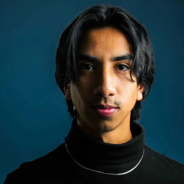 a man wearing a black turtle neck shirt