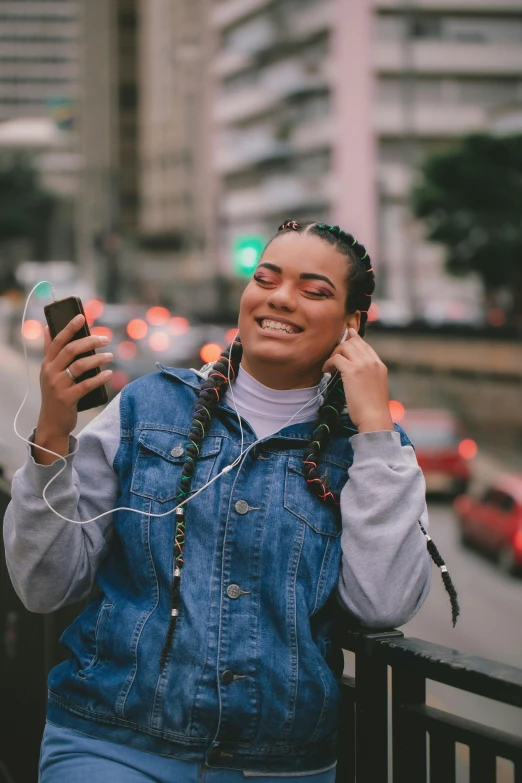 a young woman is smiling and looking down as she talks on her phone