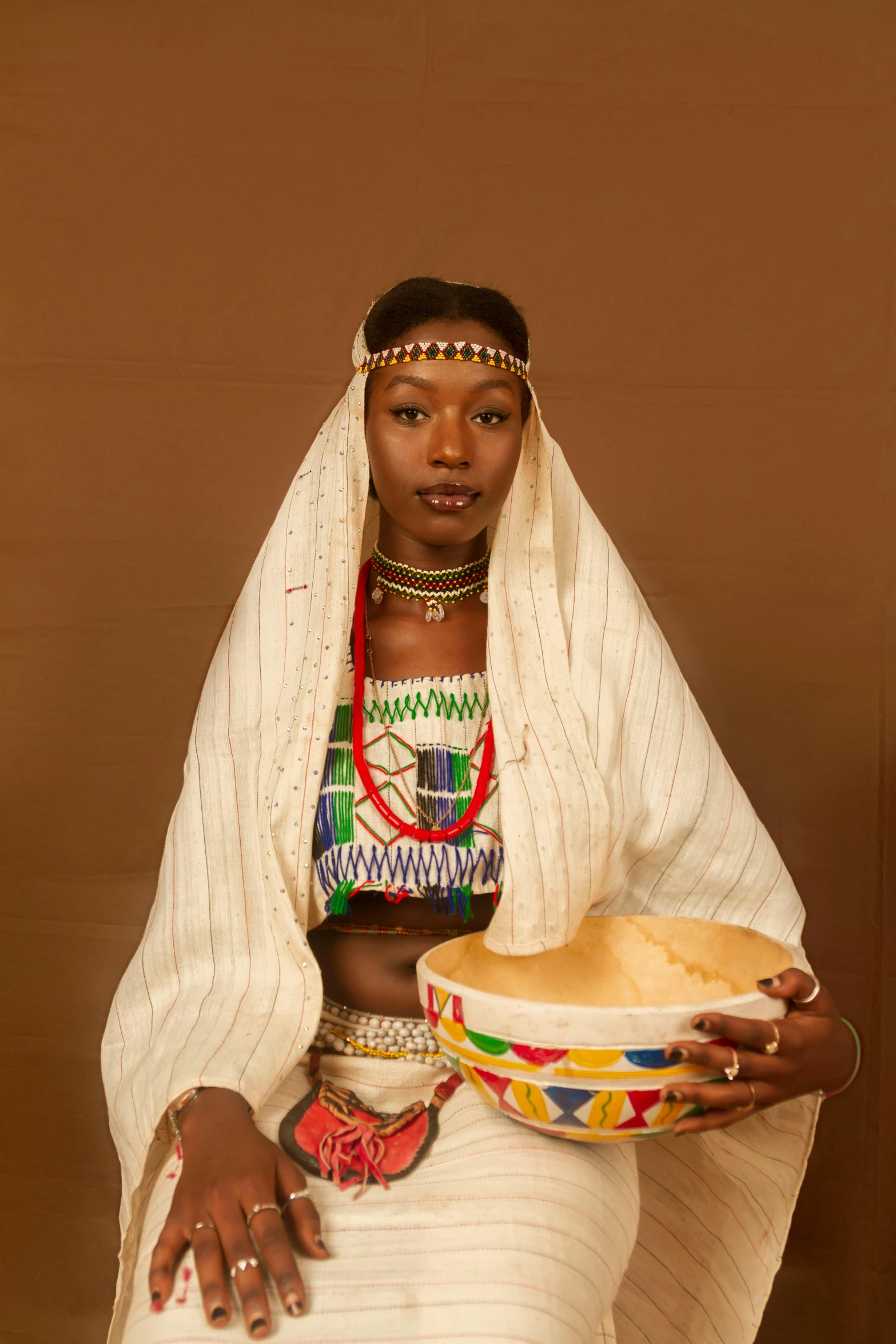 an african woman in a dress with her hat in hand