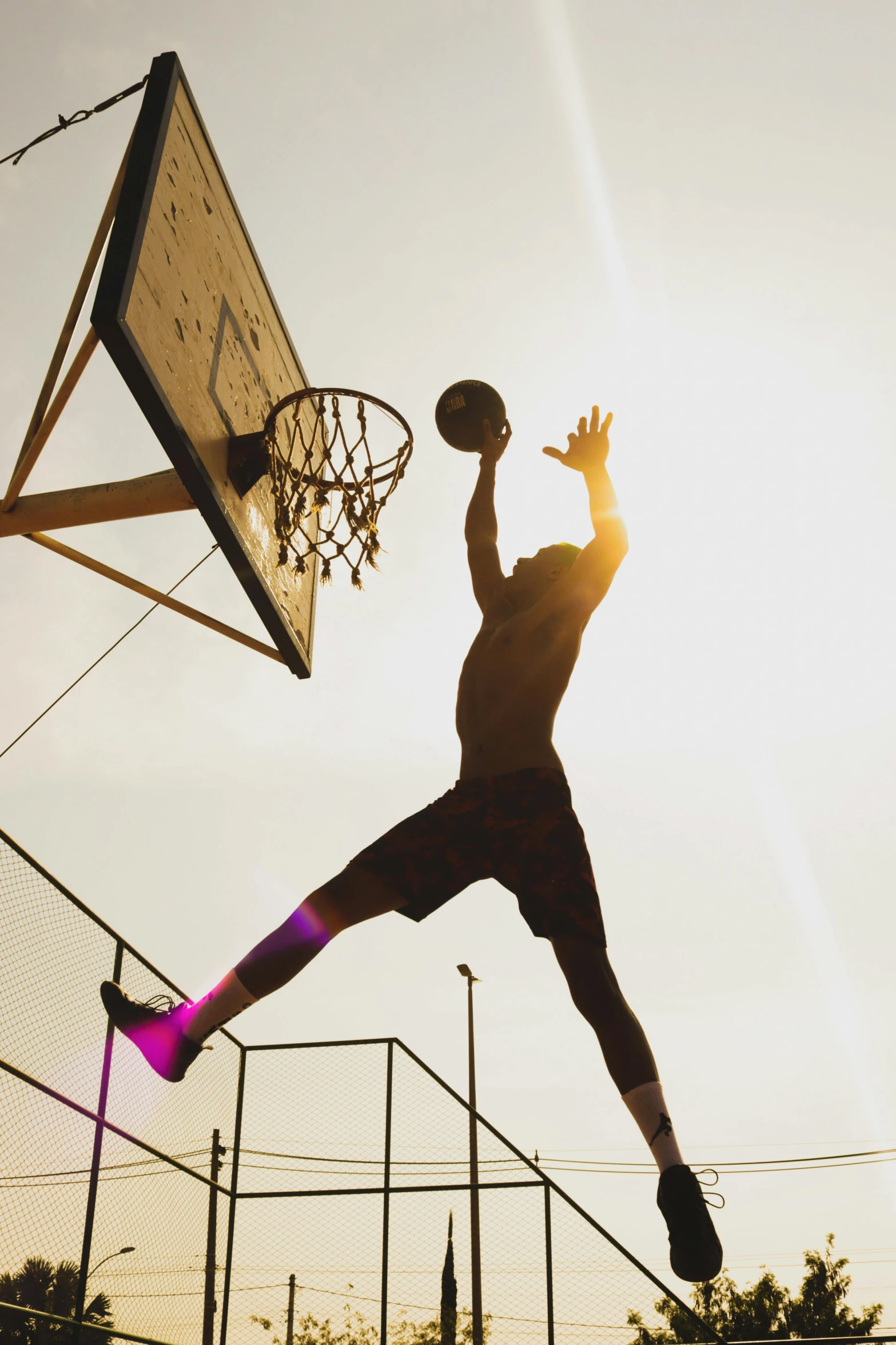 the basketball player is doing an interesting jump dunk