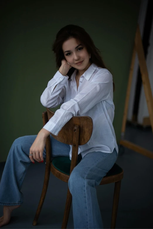 a young woman is posing in a white shirt