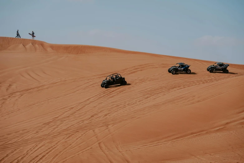 four atvs racing through a sandy area