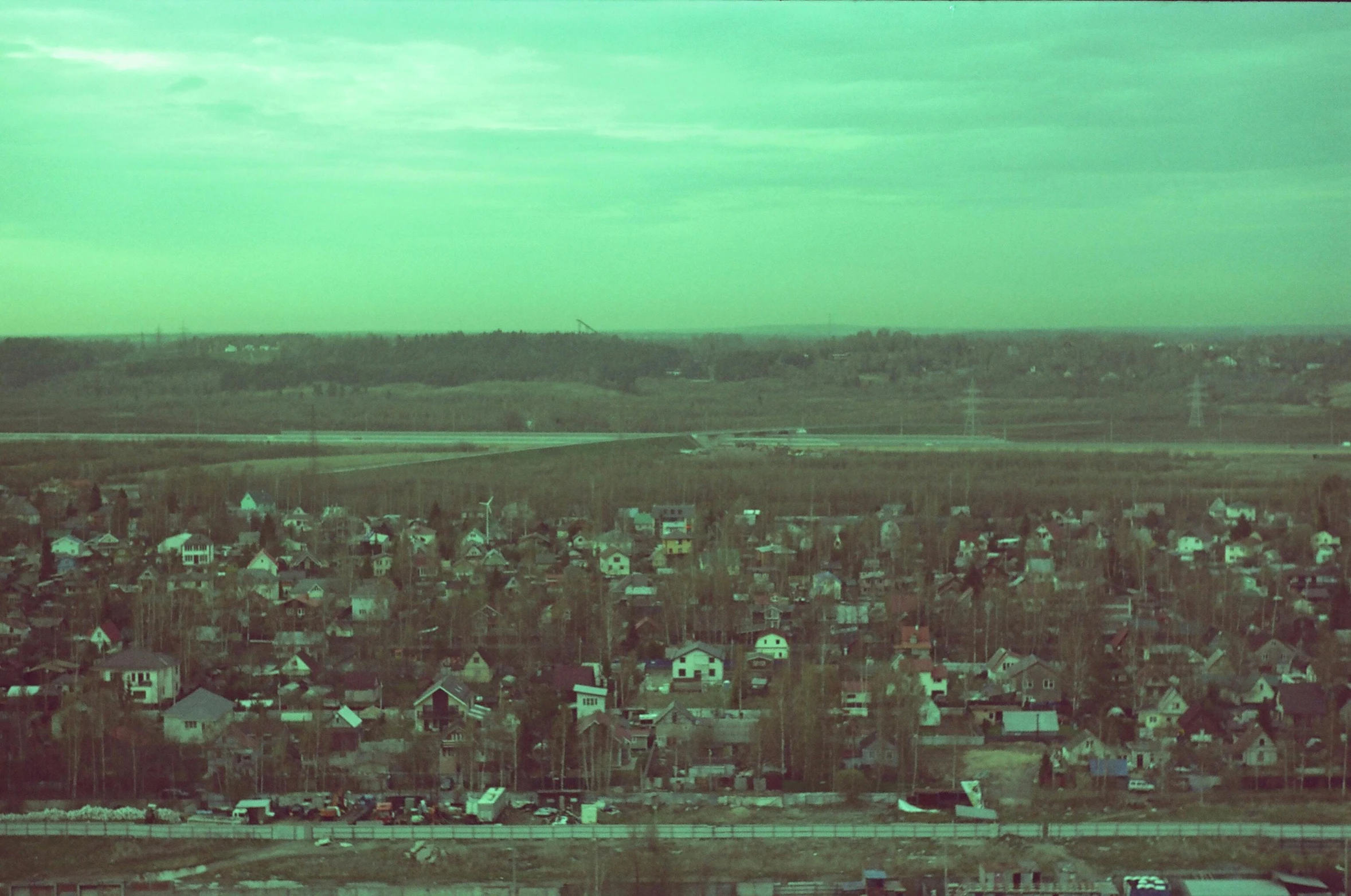 a town is seen on an island with land in the foreground