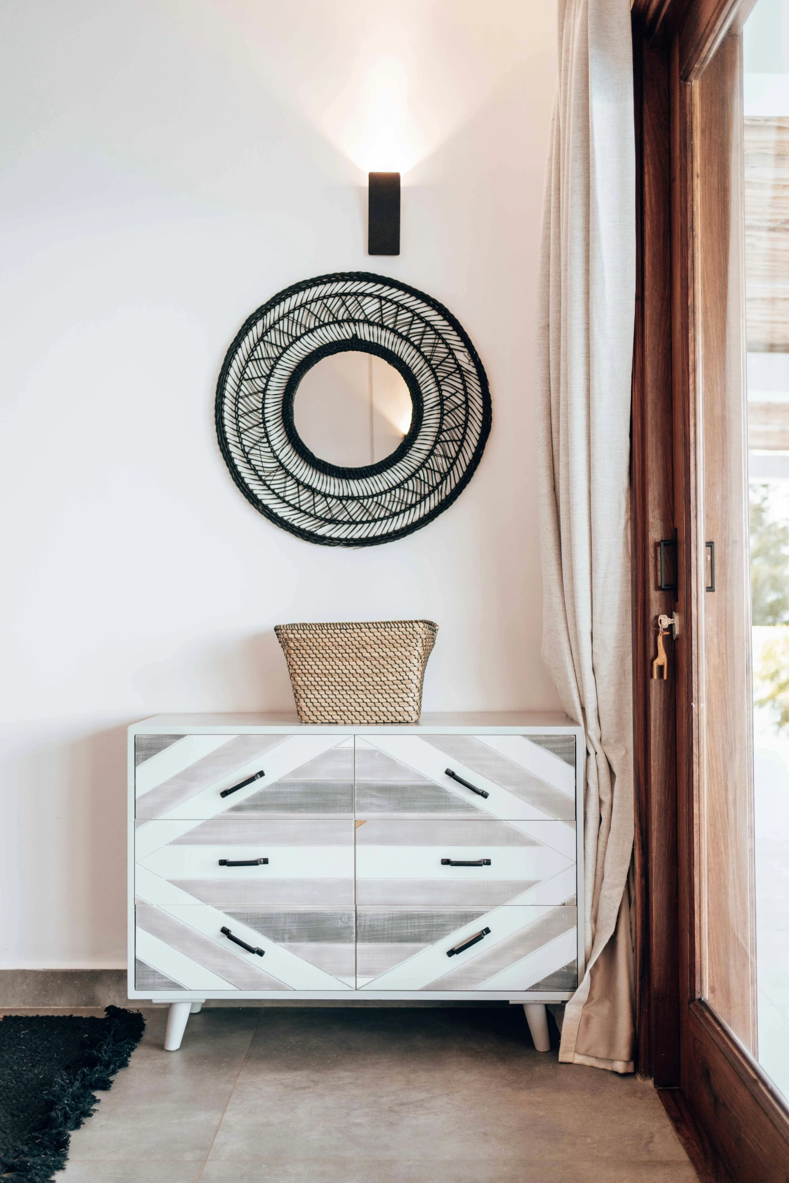 a large wall mirror and chest with a wooden base