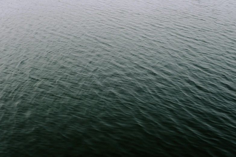 a boat floats in the middle of the ocean