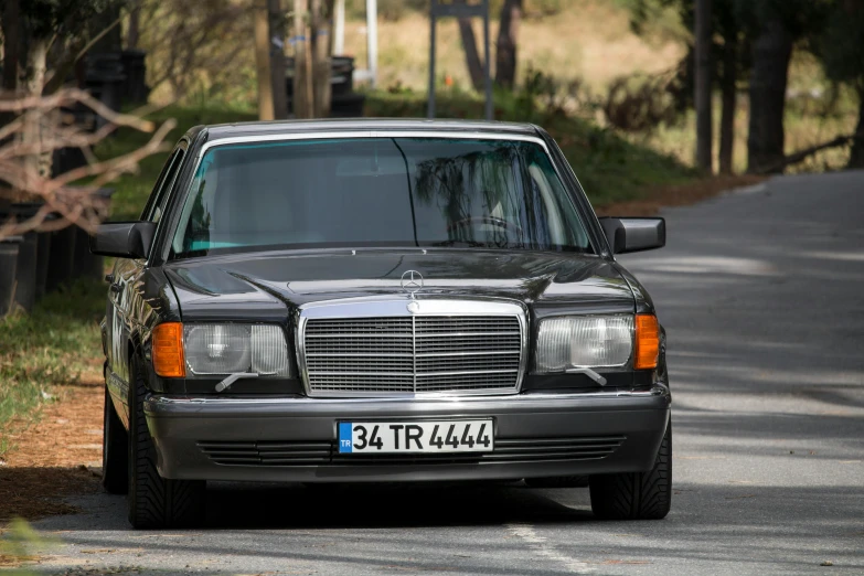 a mercedes benz is parked on the side of a road