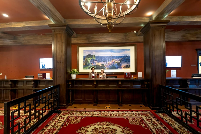 a fancy office with wooden paneling, ornate rug and chandelier