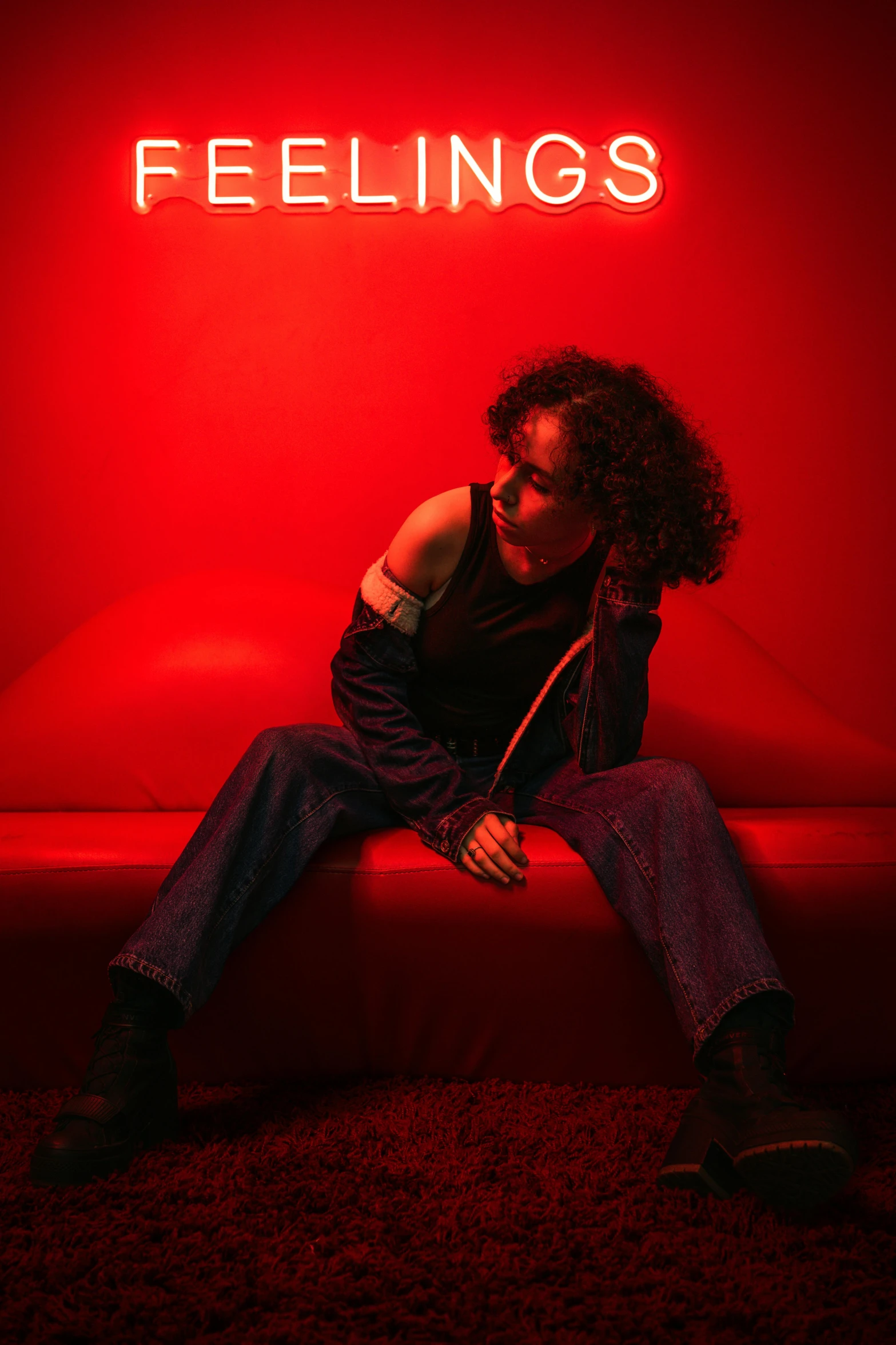 a woman sitting on a couch in a red room