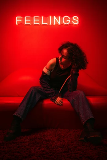 a woman sitting on a couch in a red room
