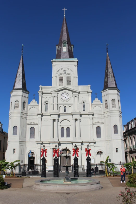 white cathedral with christmas decorations in front of it