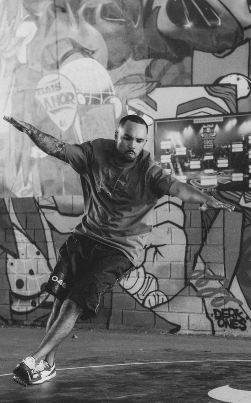 a man with a racket in a room covered in graffiti