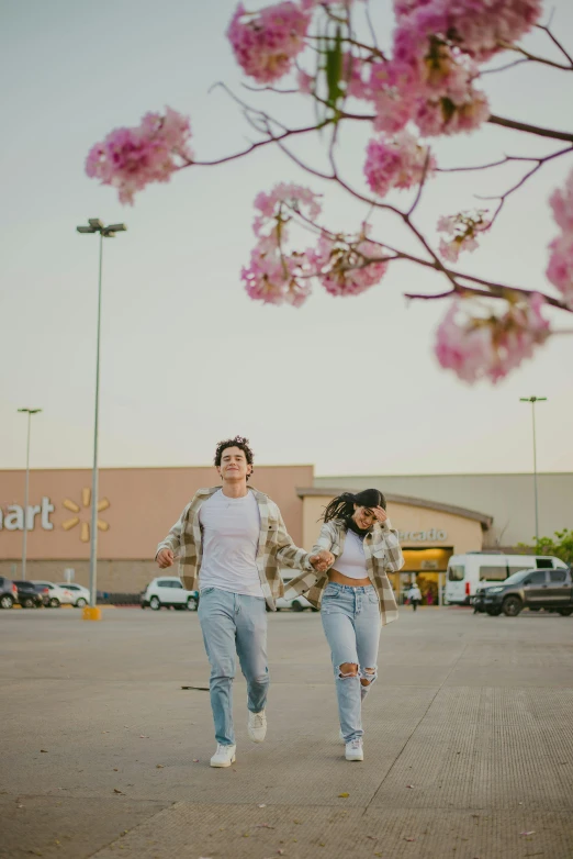 two women are running through the middle of the street