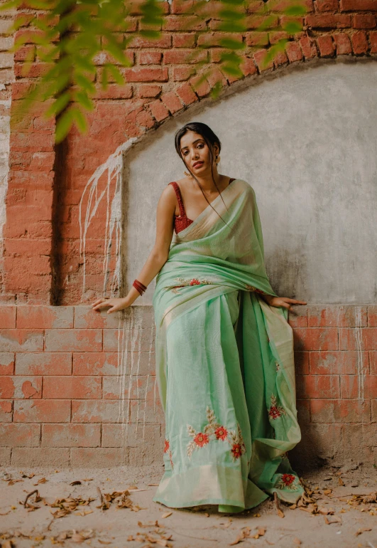 a woman leaning against a wall with her back turned to the camera