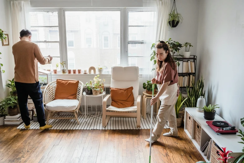 two people standing in a small living room