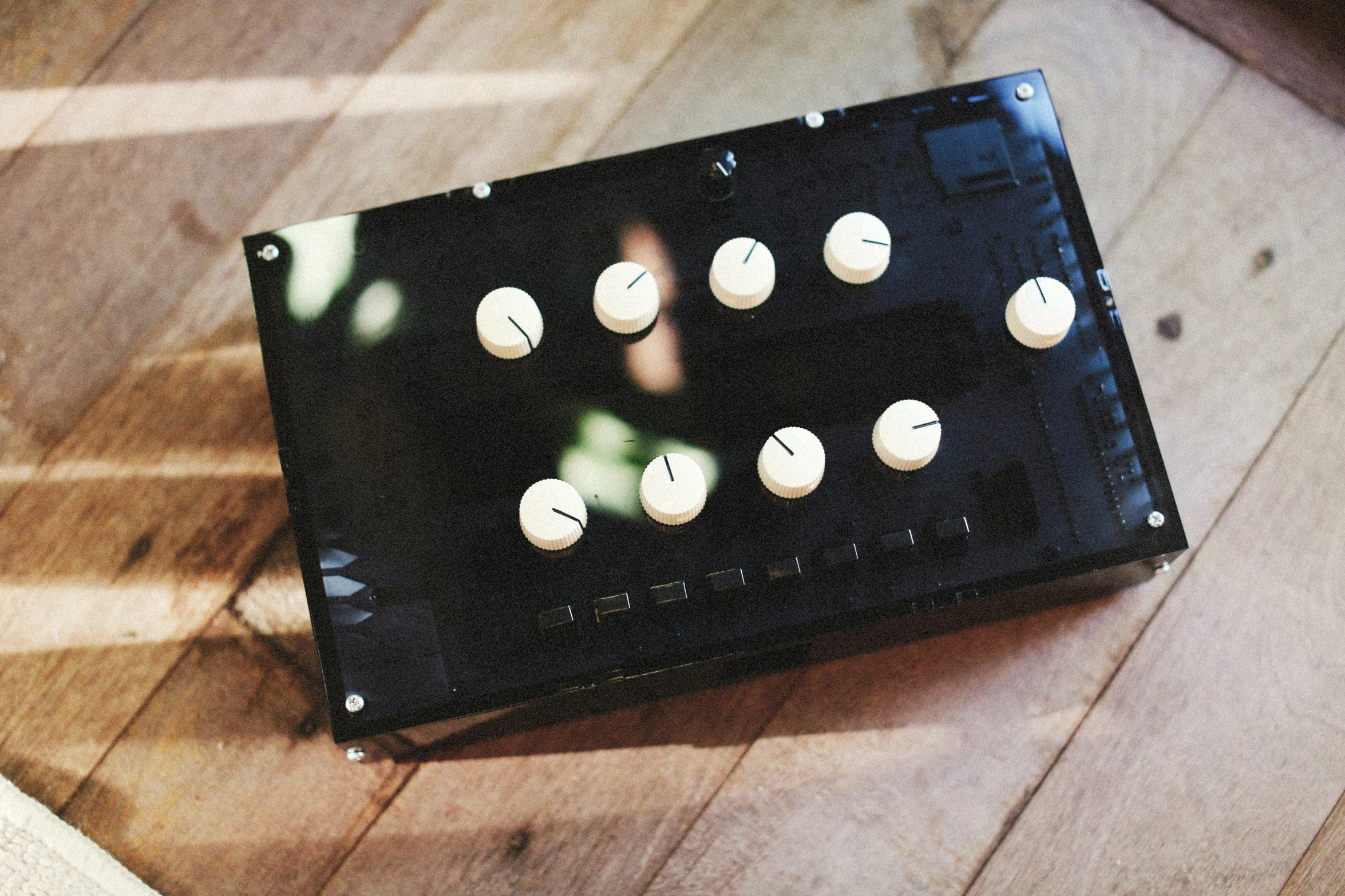 a piece of black board with white s sitting on wooden floor