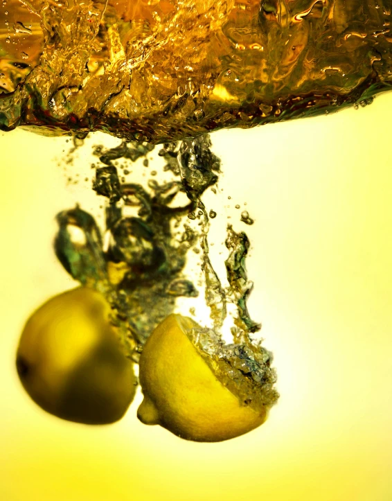 two fruits are suspended upside down in the air