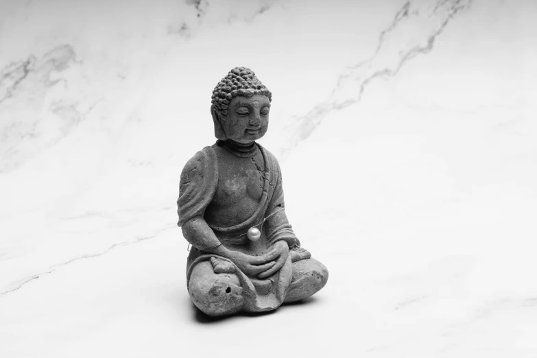 a buddha statue sitting on top of a white counter