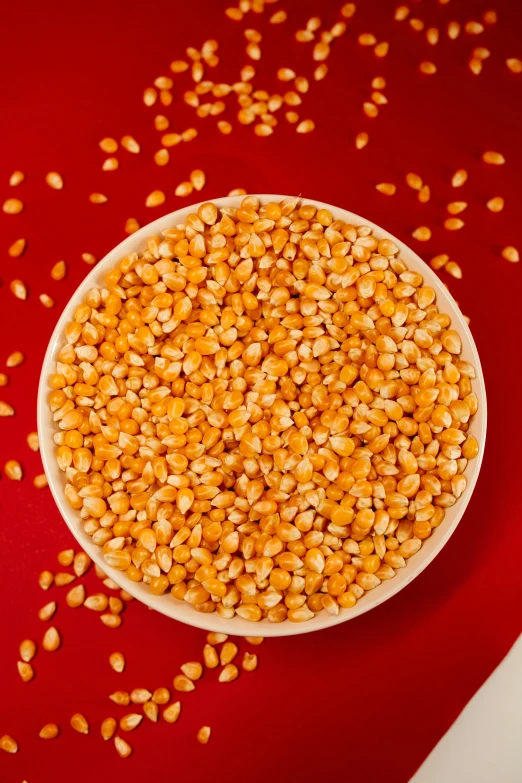 the bowl is full of cooked corn grains