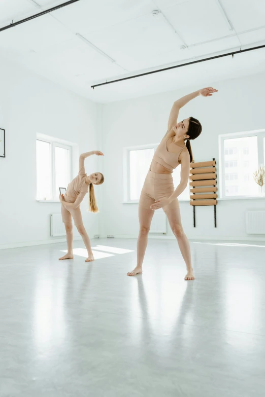 a woman doing yoga stretches with one leg up and two back