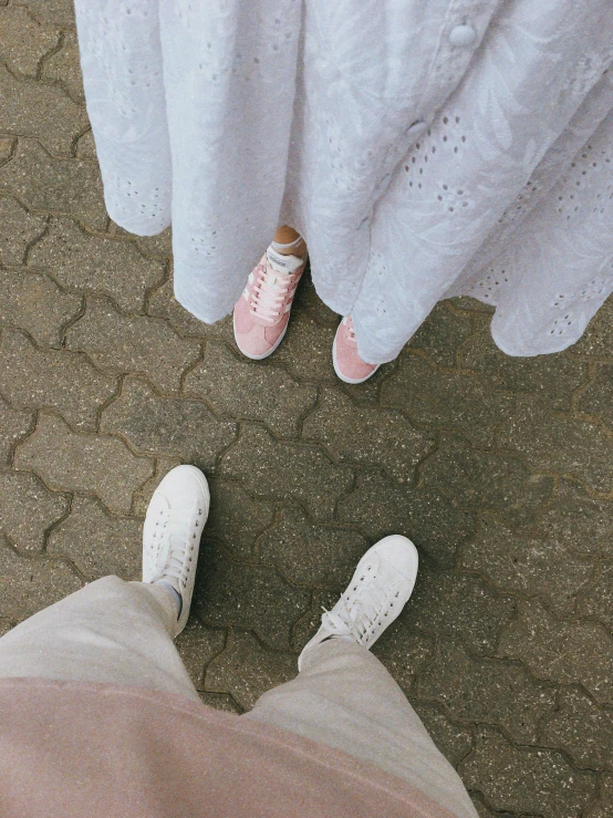 a white dress and pink tennis shoes