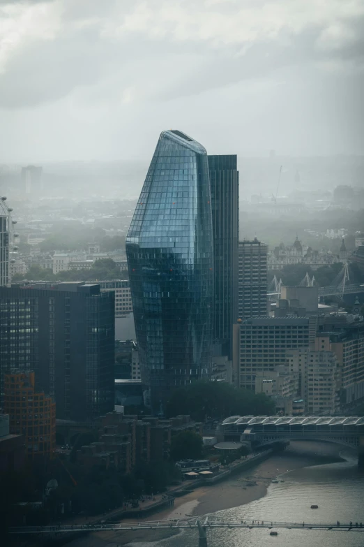 a very tall building near some buildings with lots of windows