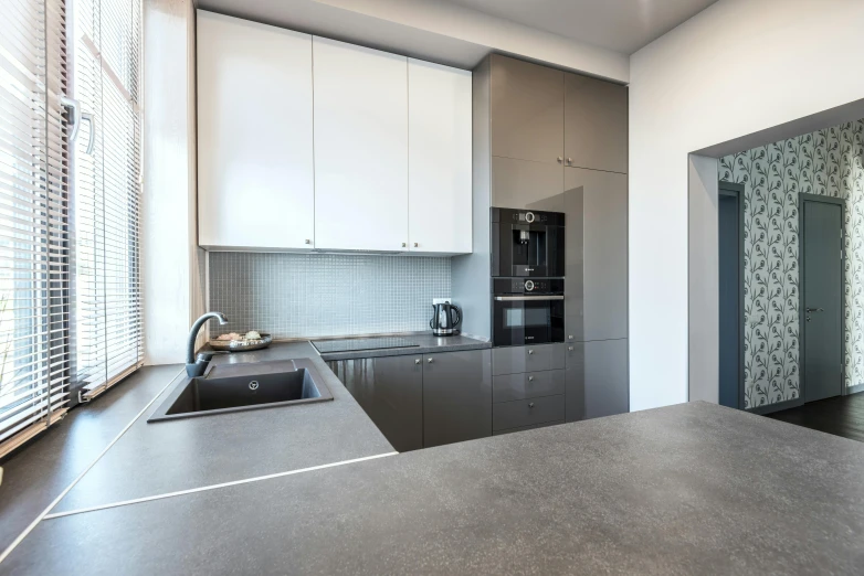 a small kitchen with a sink and stove top