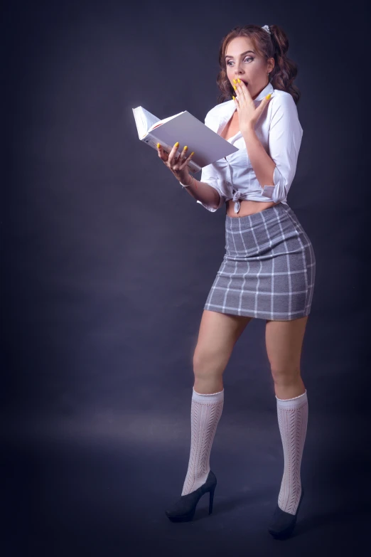 a girl dressed up with a book, skirt and socks