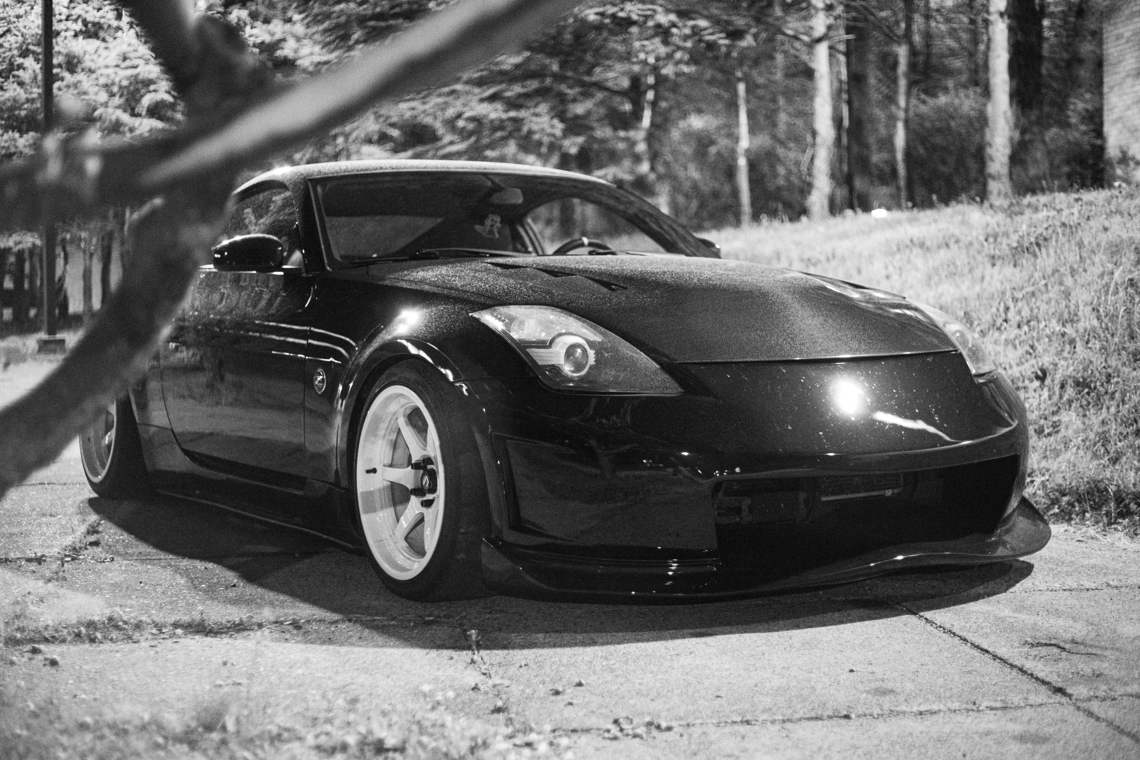 a small car sitting next to some trees