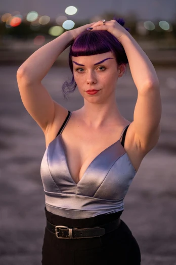 a woman with purple hair is holding her head up