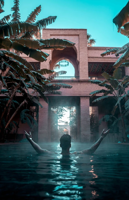 a person standing in the water with plants surrounding