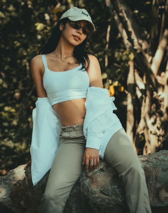 a woman posing for a po on top of a rock