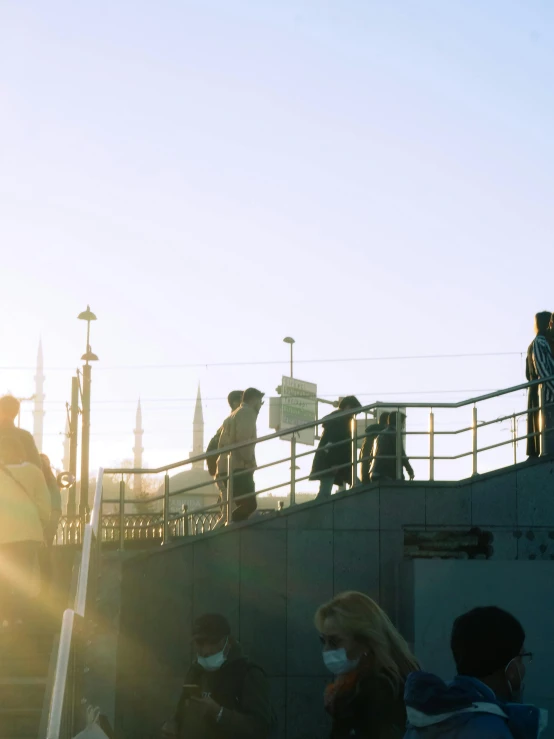 people stand on a pier with wearing masks